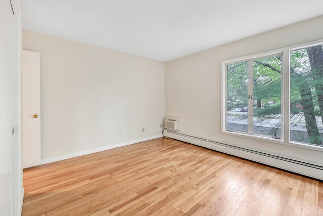 42 N Lake Dr Apt C2, Hamden, CT 06517 - spare room with wood finished floors, baseboard heating, baseboards, and a wall mounted AC