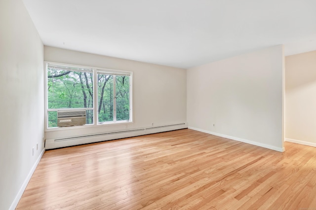 42 N Lake Dr Apt C2, Hamden, CT 06517 - unfurnished room featuring a baseboard heating unit, wood finished floors, and baseboards
