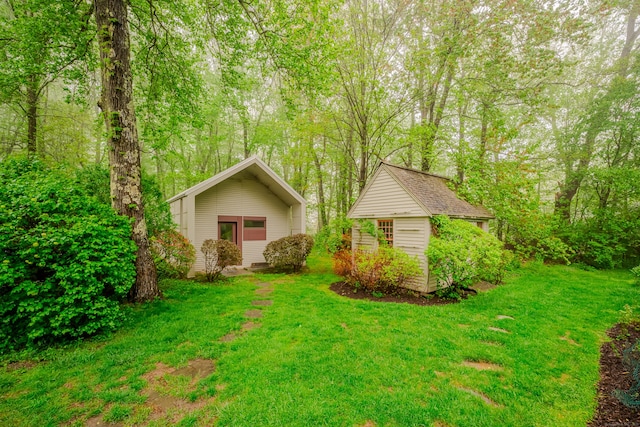 view of green lawn with an outbuilding