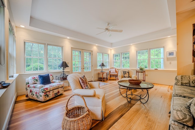 living room featuring a tray ceiling, plenty of natural light, ceiling fan, hardwood / wood-style flooring, and recessed lighting