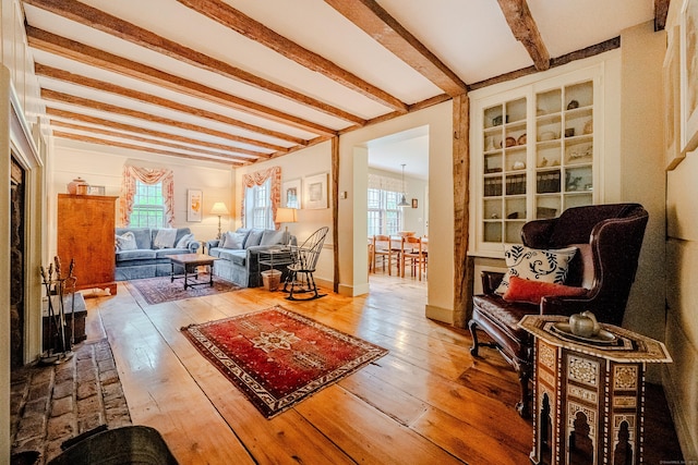 living room with beam ceiling and hardwood / wood-style flooring
