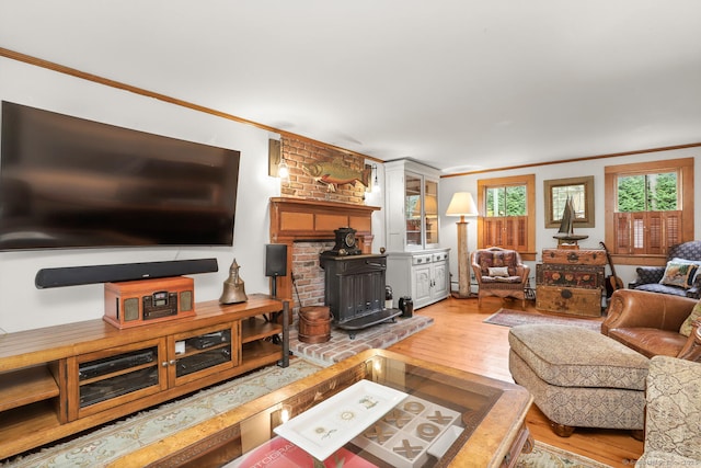 47 Hollow Tree Ridge Rd, Darien, CT 06820 - living room featuring crown molding, light wood-style flooring, and a wood stove