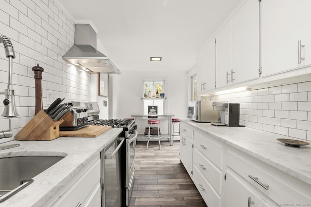 47 Hollow Tree Ridge Rd, Darien, CT 06820 - kitchen with wall chimney exhaust hood, appliances with stainless steel finishes, dark wood-type flooring, backsplash, and white cabinets
