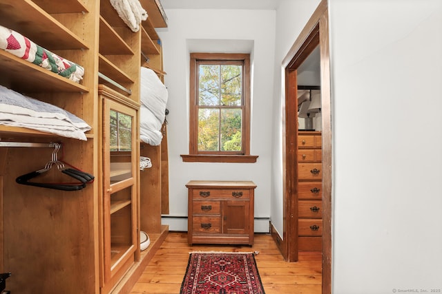 47 Hollow Tree Ridge Rd, Darien, CT 06820 - doorway with light wood-style floors, baseboard heating, and a baseboard heating unit