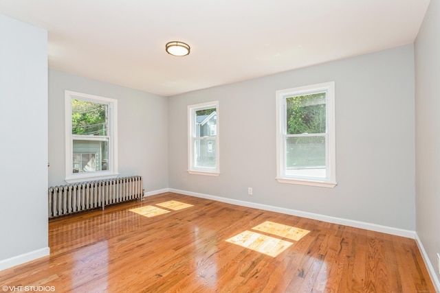 70 Maple St, Meriden, CT 06451 - unfurnished room with radiator heating unit, baseboards, and light wood-style floors