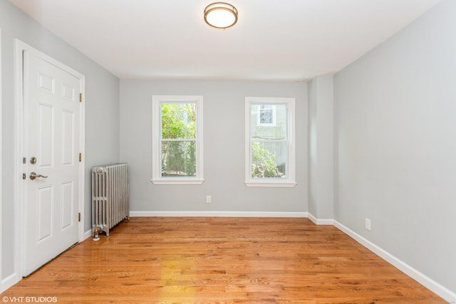 70 Maple St, Meriden, CT 06451 - empty room with radiator, light wood-type flooring, and baseboards
