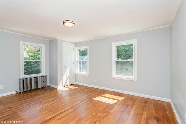 70 Maple St, Meriden, CT 06451 - empty room with radiator, baseboards, light wood-type flooring, plenty of natural light, and crown molding