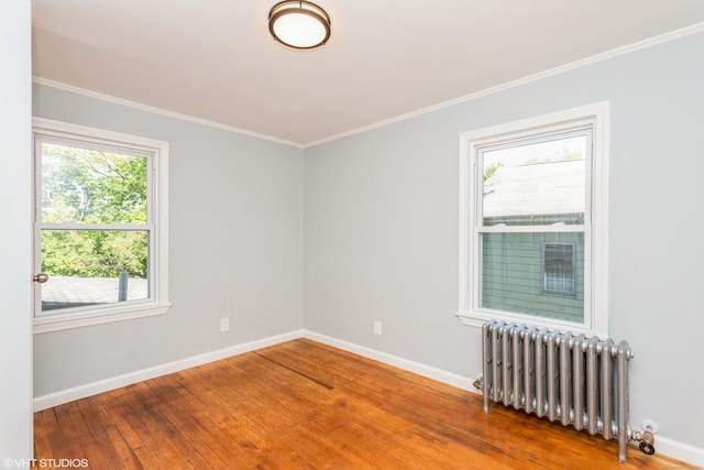 70 Maple St, Meriden, CT 06451 - empty room with radiator, baseboards, wood finished floors, and ornamental molding
