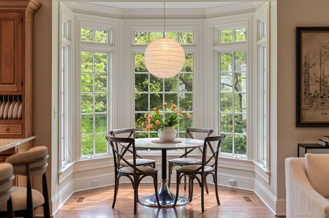 dining area with light wood-style flooring, healthy amount of natural light, and baseboards