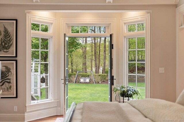 doorway to outside with healthy amount of natural light and baseboards