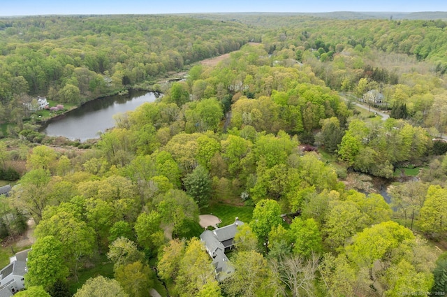 bird's eye view of a heavily wooded area and a nearby body of water