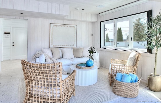 living area with wood walls