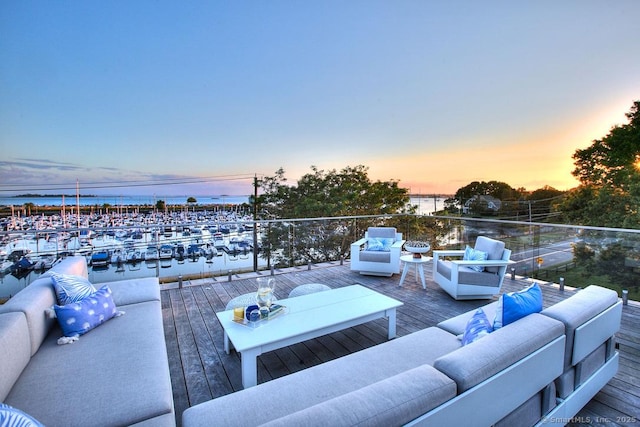 view of patio featuring outdoor lounge area, a water view, and view of marina