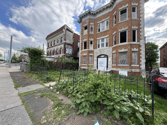 view of building exterior featuring fence