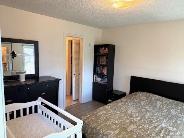 202 Carriage Crossing Ln Unit 202, Middletown, CT 06457 - bedroom featuring light wood finished floors and a textured ceiling