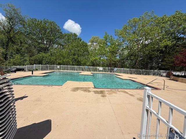 202 Carriage Crossing Ln Unit 202, Middletown, CT 06457 - community pool featuring a patio area and view of wooded area