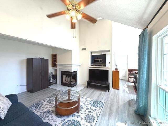 202 Carriage Crossing Ln Unit 202, Middletown, CT 06457 - living area with wood finished floors, a ceiling fan, a fireplace, and high vaulted ceiling