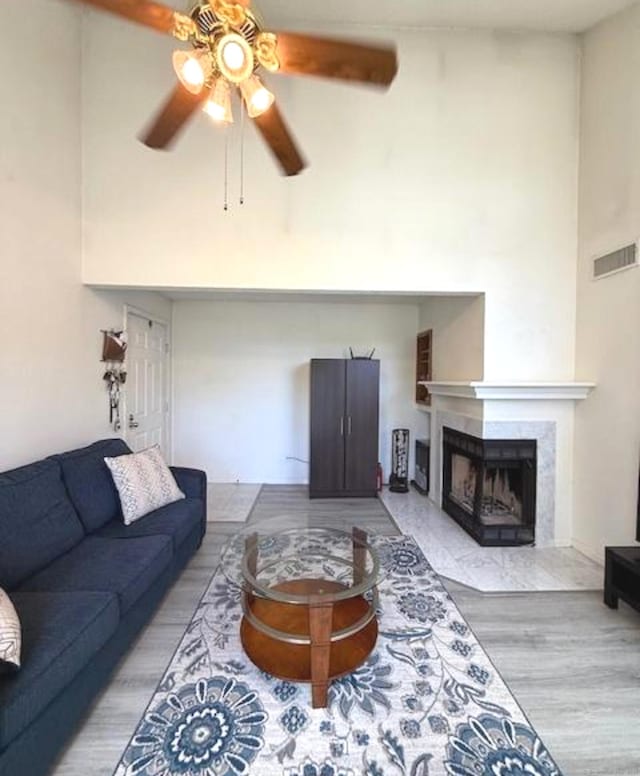 202 Carriage Crossing Ln Unit 202, Middletown, CT 06457 - living area with a ceiling fan, a premium fireplace, wood finished floors, and a high ceiling