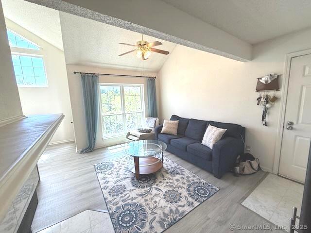 202 Carriage Crossing Ln Unit 202, Middletown, CT 06457 - living room featuring vaulted ceiling, wood finished floors, ceiling fan, baseboards, and a textured ceiling