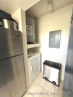 202 Carriage Crossing Ln Unit 202, Middletown, CT 06457 - kitchen featuring light tile patterned floors, washer / dryer, electric panel, and water heater