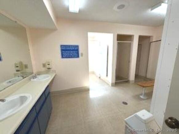 202 Carriage Crossing Ln Unit 202, Middletown, CT 06457 - full bath featuring double vanity, a stall shower, baseboards, and tile patterned floors