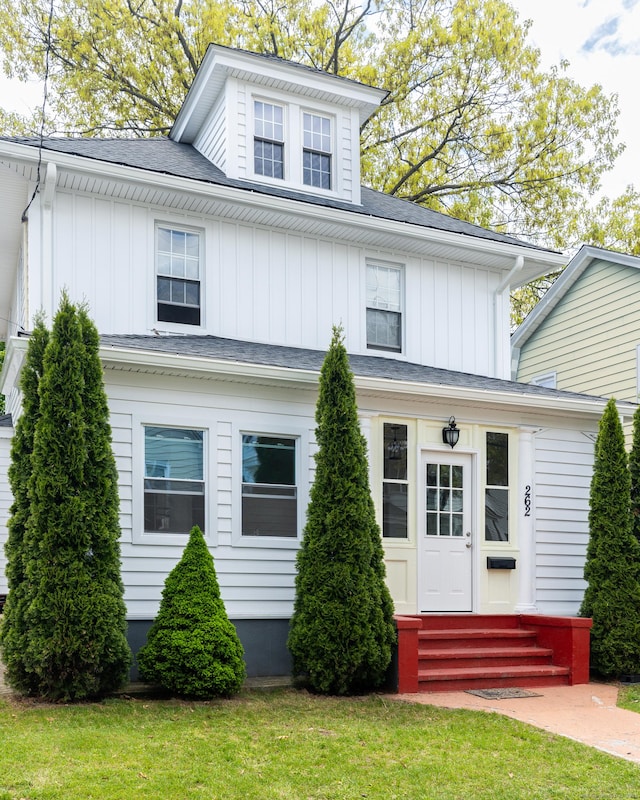262 Blohm St, West Haven, CT 06516 - american foursquare style home with entry steps, board and batten siding, a front yard, and roof with shingles