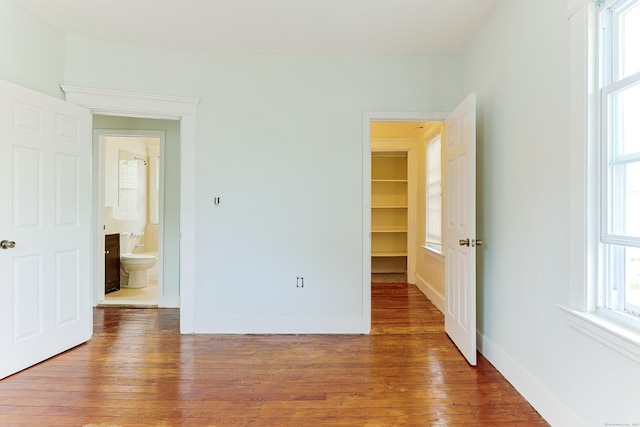 262 Blohm St, West Haven, CT 06516 - unfurnished bedroom with wood-type flooring, baseboards, and a spacious closet