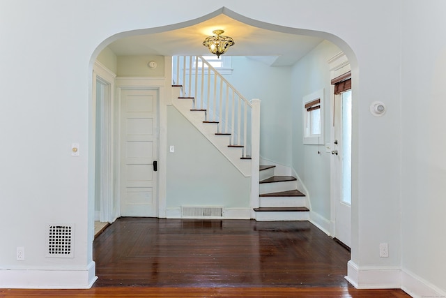 262 Blohm St, West Haven, CT 06516 - entryway featuring arched walkways, stairway, wood finished floors, and baseboards