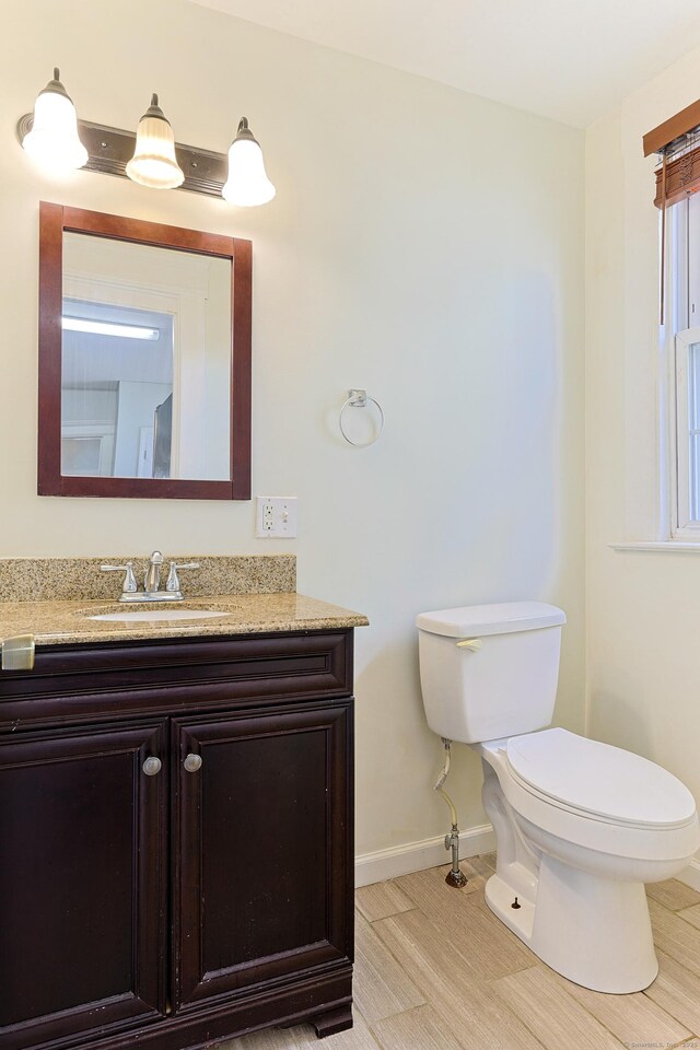 262 Blohm St, West Haven, CT 06516 - bathroom featuring baseboards, toilet, and vanity