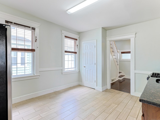 262 Blohm St, West Haven, CT 06516 - spare room featuring light wood-style flooring, stairway, and baseboards
