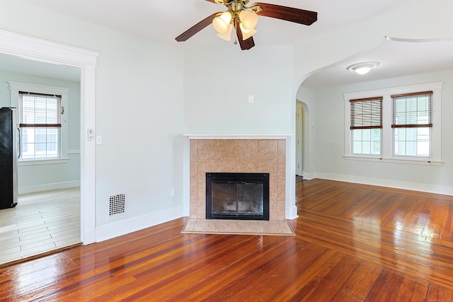 262 Blohm St, West Haven, CT 06516 - unfurnished living room featuring wood-type flooring, plenty of natural light, ceiling fan, and a tile fireplace