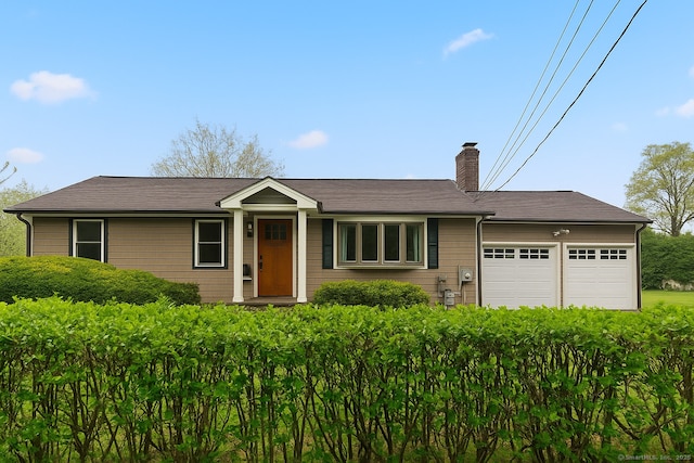 single story home featuring a chimney and a garage