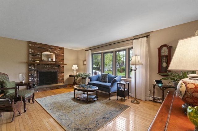 living room featuring light wood-style floors and a brick fireplace