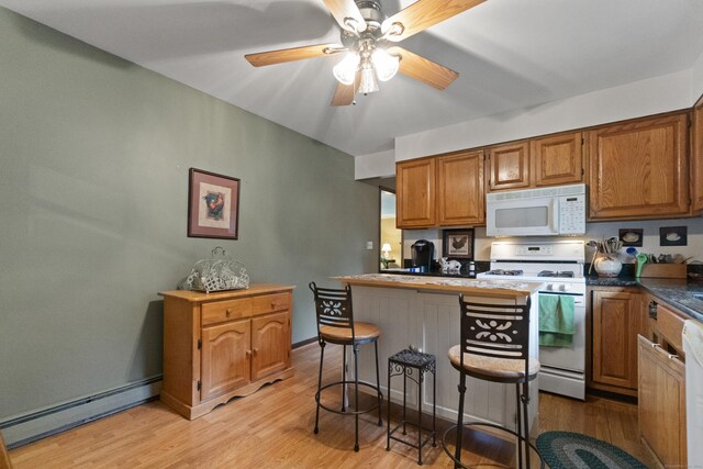 kitchen with white appliances, a baseboard radiator, light wood-style floors, brown cabinets, and ceiling fan