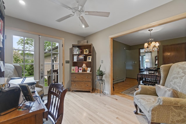 home office with a baseboard radiator, a chandelier, light wood-style floors, ceiling fan, and baseboards