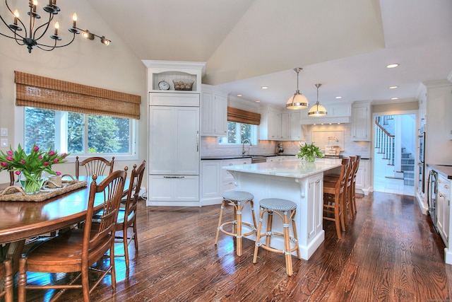 63 Balfour Dr, West Hartford, CT 06117 - kitchen featuring a chandelier, a kitchen island, decorative backsplash, white cabinets, and dark wood-type flooring