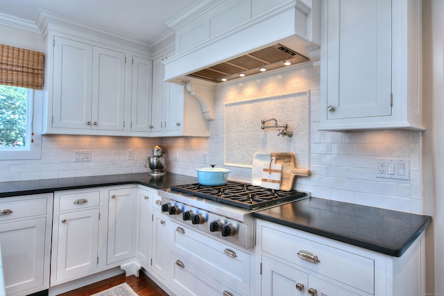 63 Balfour Dr, West Hartford, CT 06117 - kitchen with custom range hood, stainless steel gas stovetop, dark countertops, tasteful backsplash, and ornamental molding
