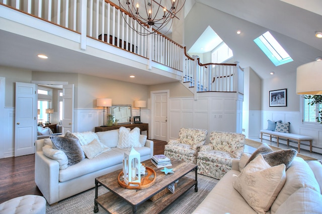 63 Balfour Dr, West Hartford, CT 06117 - living room with a towering ceiling, a decorative wall, wainscoting, a skylight, and stairway