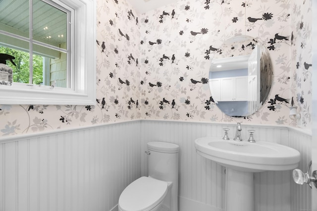 140 Podunk Rd, Guilford, CT 06437 - half bath featuring wallpapered walls, a wainscoted wall, and toilet