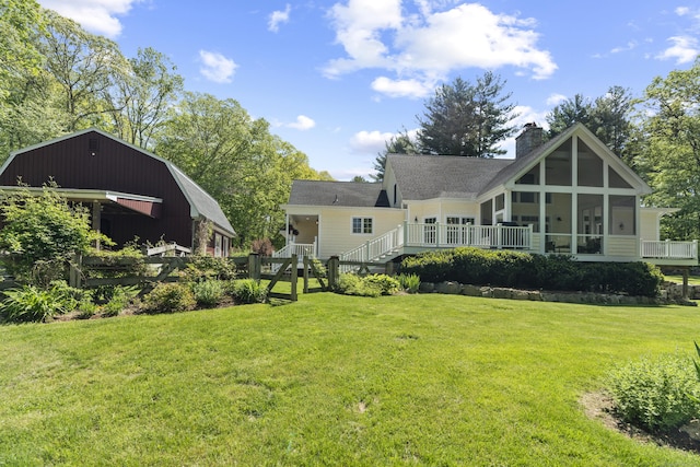 140 Podunk Rd, Guilford, CT 06437 - rear view of property with a lawn, a chimney, a sunroom, and a wooden deck