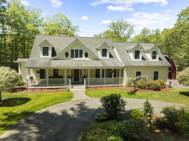 140 Podunk Rd, Guilford, CT 06437 - new england style home featuring a shingled roof, covered porch, and a front lawn