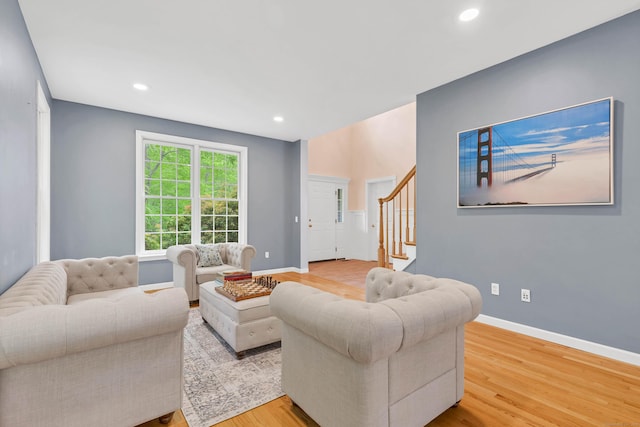 living area featuring wood finished floors, stairway, recessed lighting, and baseboards