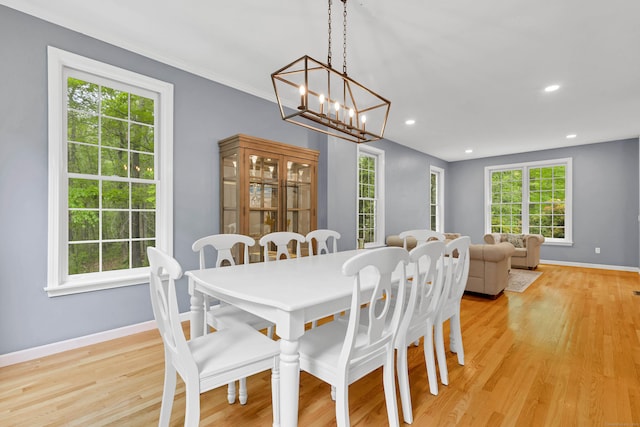 dining space featuring baseboards, a chandelier, light wood-style floors, plenty of natural light, and recessed lighting