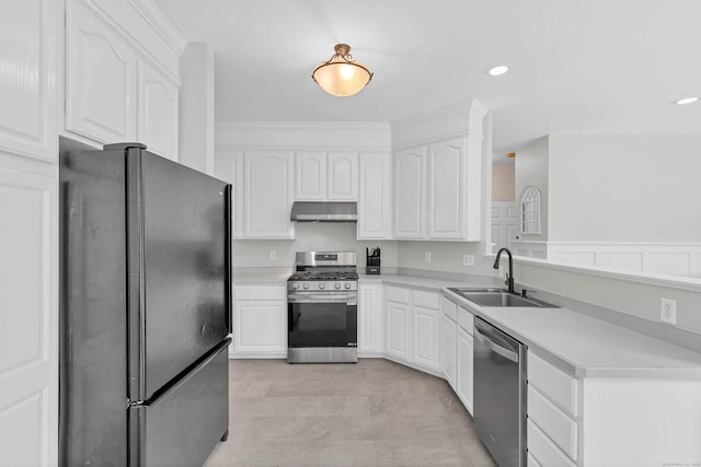 kitchen with stainless steel appliances, a sink, under cabinet range hood, white cabinets, and light countertops