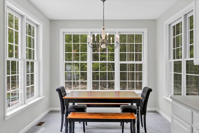 dining space with a chandelier, plenty of natural light, and baseboards