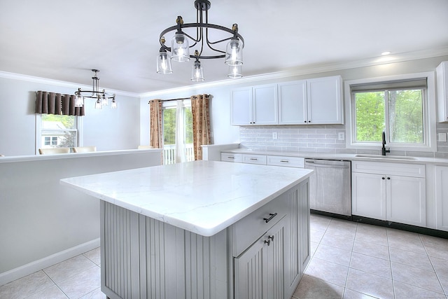 23 Davis Rd, Seymour, CT 06483 - kitchen featuring stainless steel dishwasher, a chandelier, light tile patterned floors, ornamental molding, and healthy amount of natural light