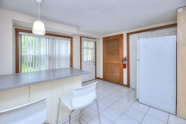 23 Davis Rd, Seymour, CT 06483 - kitchen featuring freestanding refrigerator, decorative light fixtures, light tile patterned floors, and light countertops