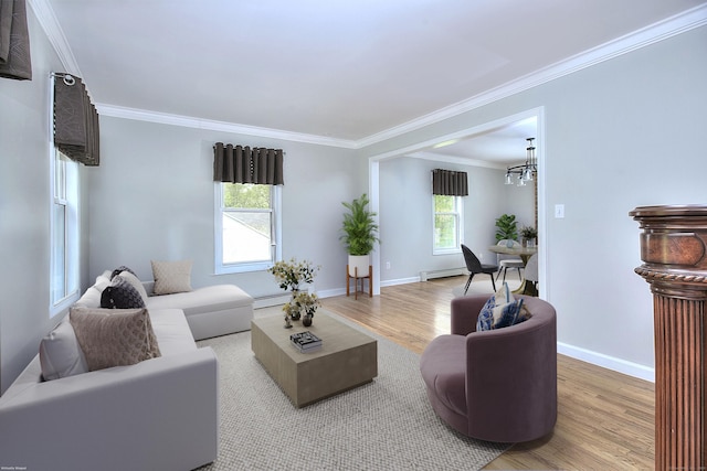 23 Davis Rd, Seymour, CT 06483 - living area featuring light wood finished floors, a chandelier, crown molding, and a baseboard heating unit