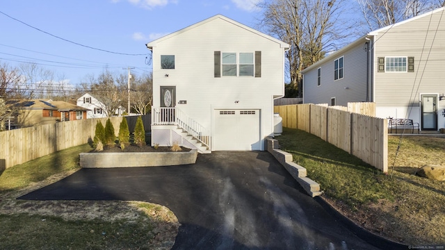 6 Bidwell Ter, Middletown, CT 06457 - view of front of home featuring a garage, fence, and driveway
