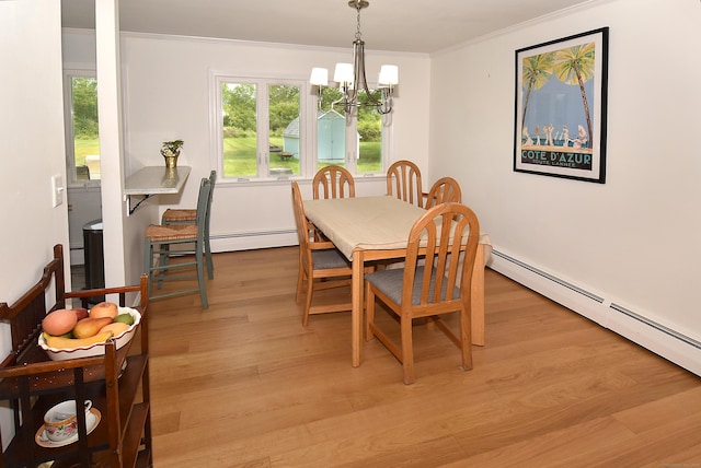 21 Craigmore Rd, Bloomfield, CT 06002 - dining area featuring a chandelier, ornamental molding, a baseboard heating unit, and light wood-style flooring